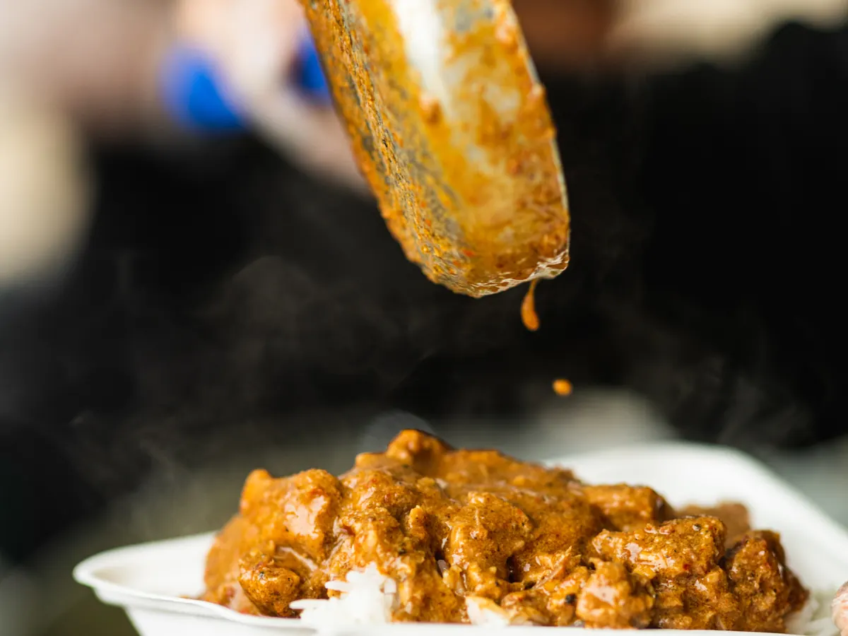 Massaman curry being plated fresh at the Tippy's Thai stall