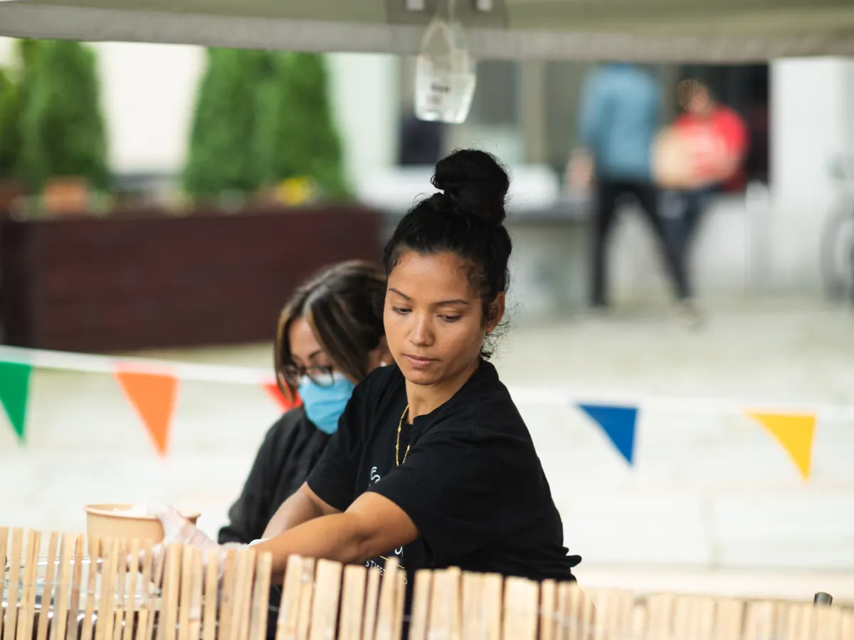 Niang's Thai Street Food stall banner with staff preparing orders
