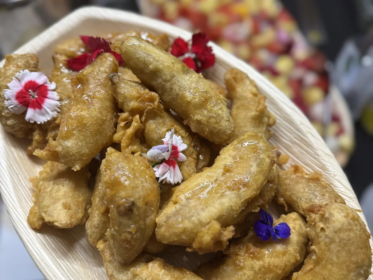 Crispy battered canapés finished with edible flowers, served at a Tippy's Thai catered event